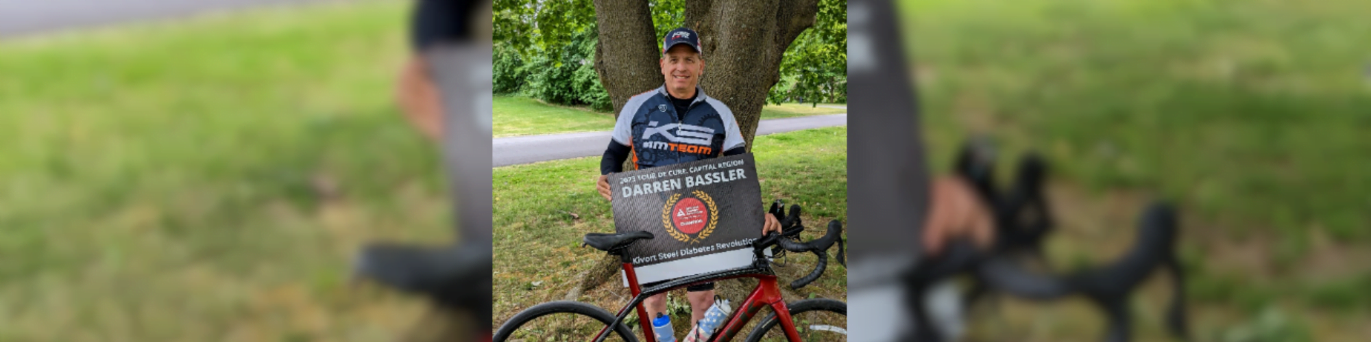 Darren Bassler standing behind his bike