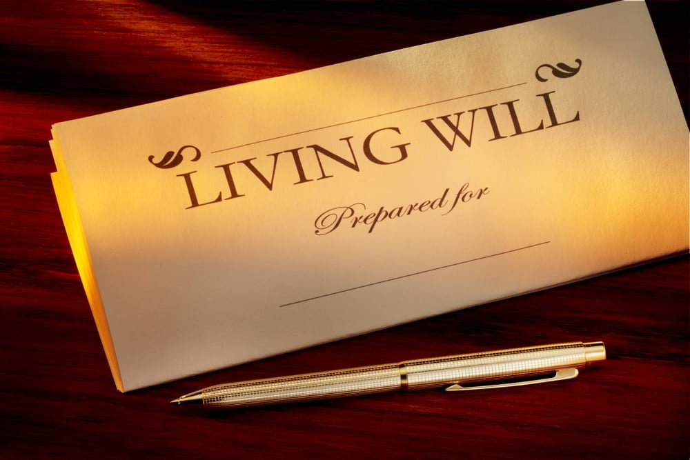 living will with gold pen shot on warm wood desk